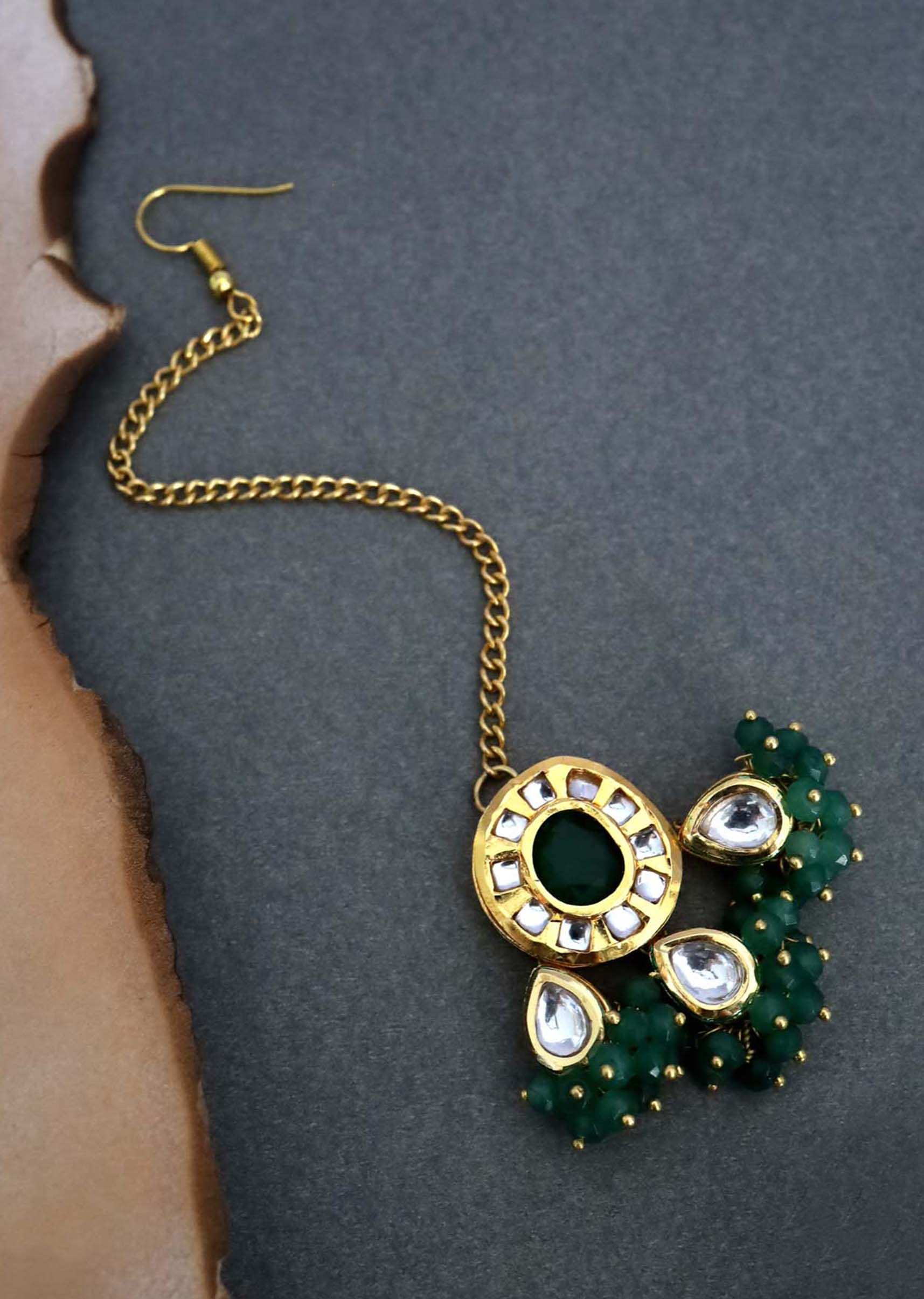 Gold Plated Mangtika With Kundan And Green Stone Centre With Dangling Smaller Stones