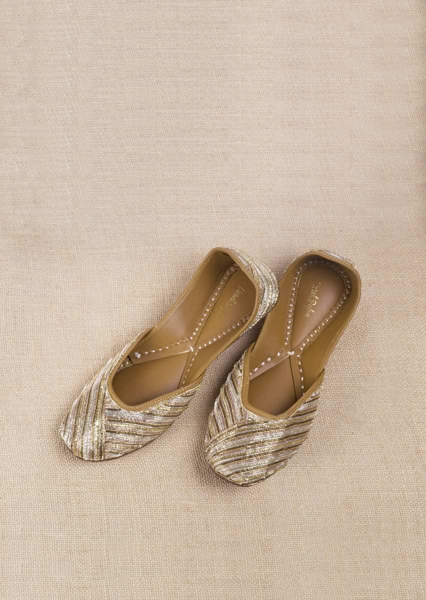 Golden And Silver Juttis In Linen With Zari Work In Linear Motifs By Vareli Bafna