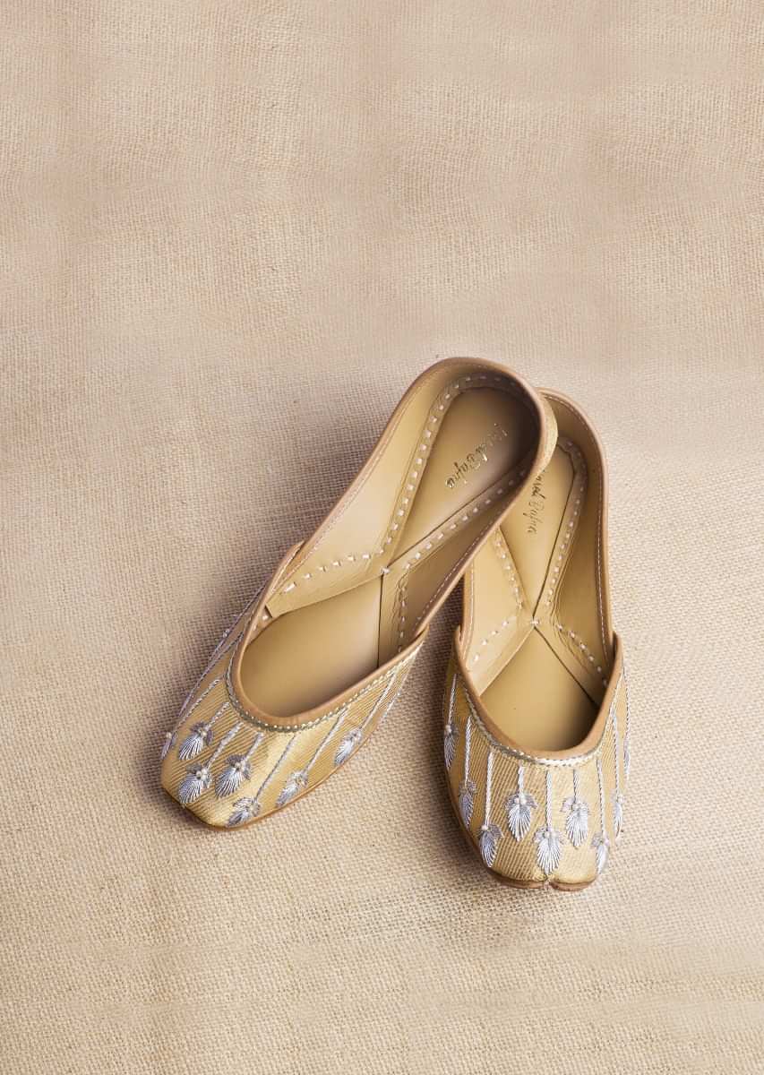 Golden Juttis In Banarasi Fabric With Silver Zari Embroidery Along With Fresh Water Pearl Accents By Vareli Bafna