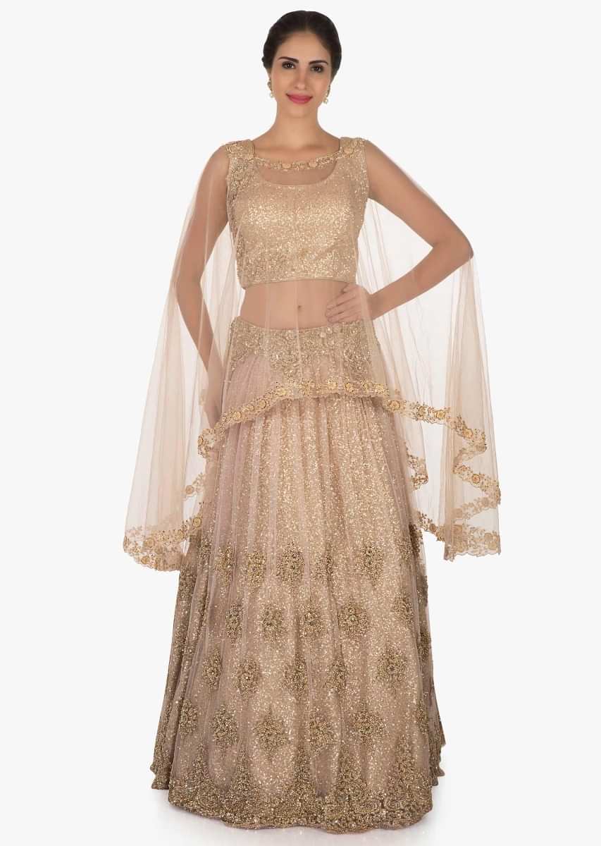 Golden lehenga with a cape enhanced in heavy sequin embroidery work only on Kalki