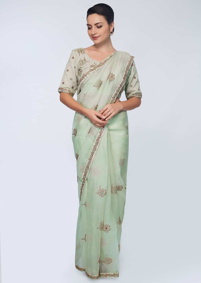 Green organza saree with embroidered butti and border 