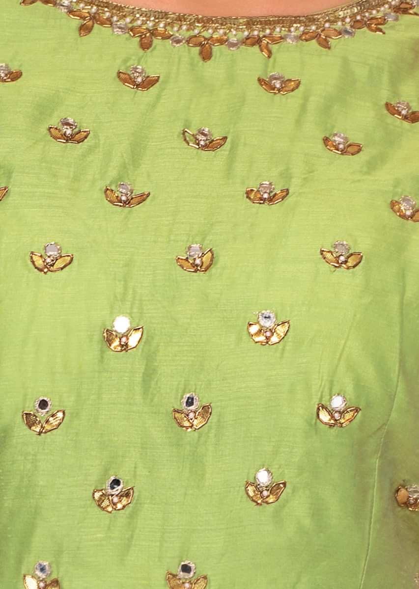 Green silk anarkali dress paired with grey weaved dupatta