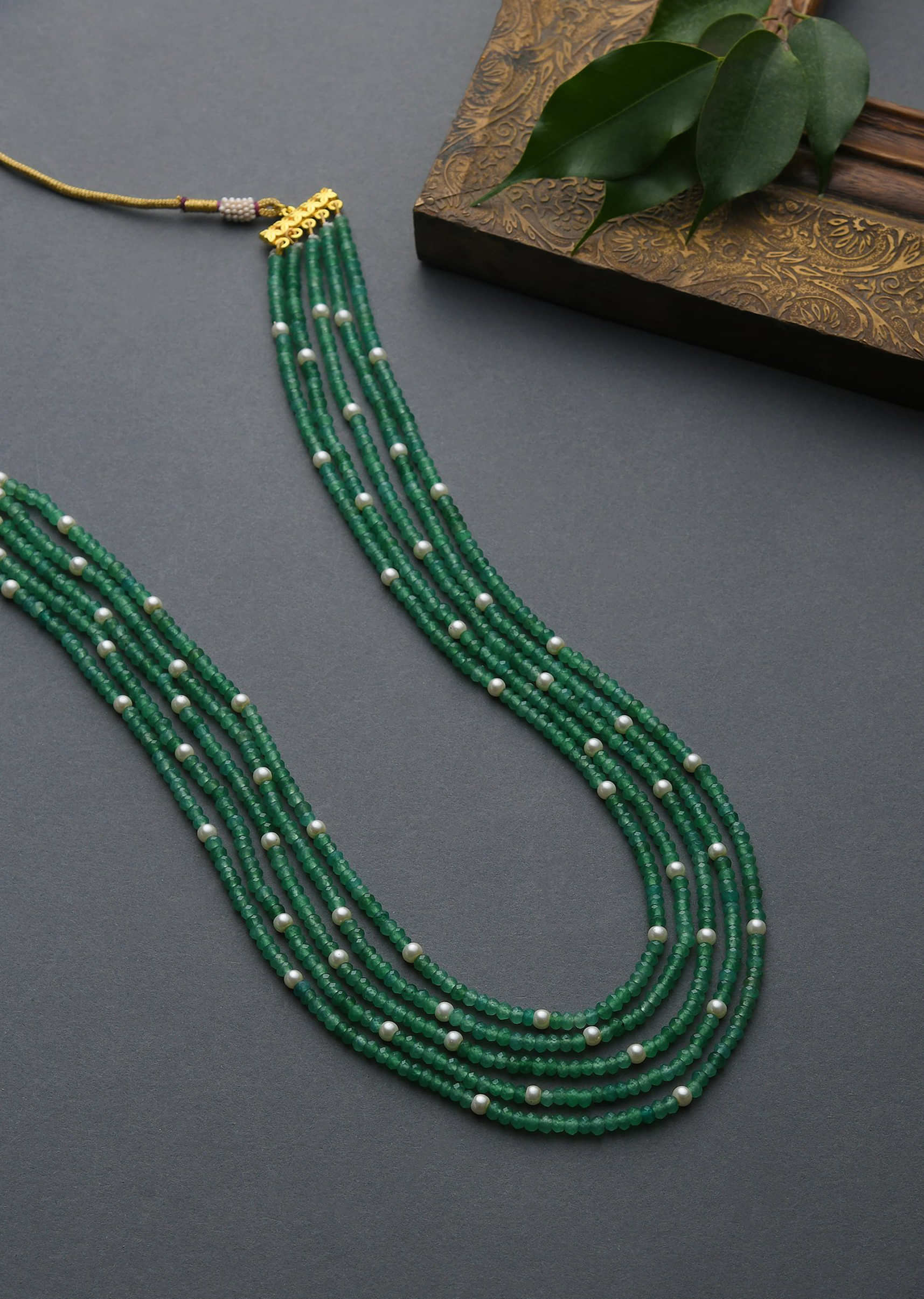 Green Necklace With Multiple Bead Strings And White Stone Accents