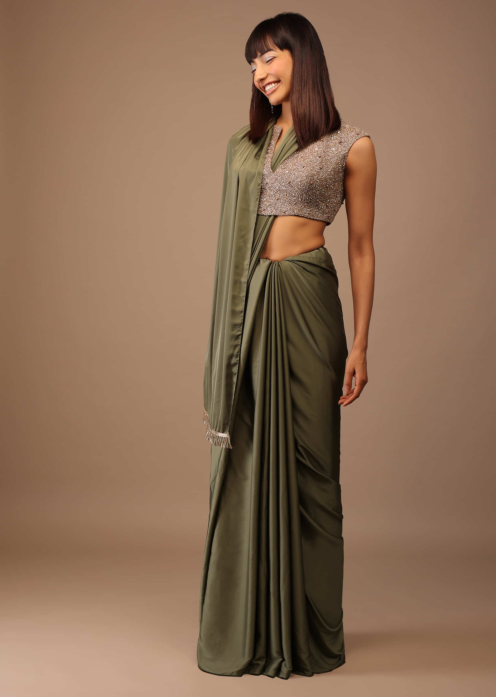 Green Satin Saree With Fringes On Pallu Paired With Deep Neck Hand Embroidered Crop Top