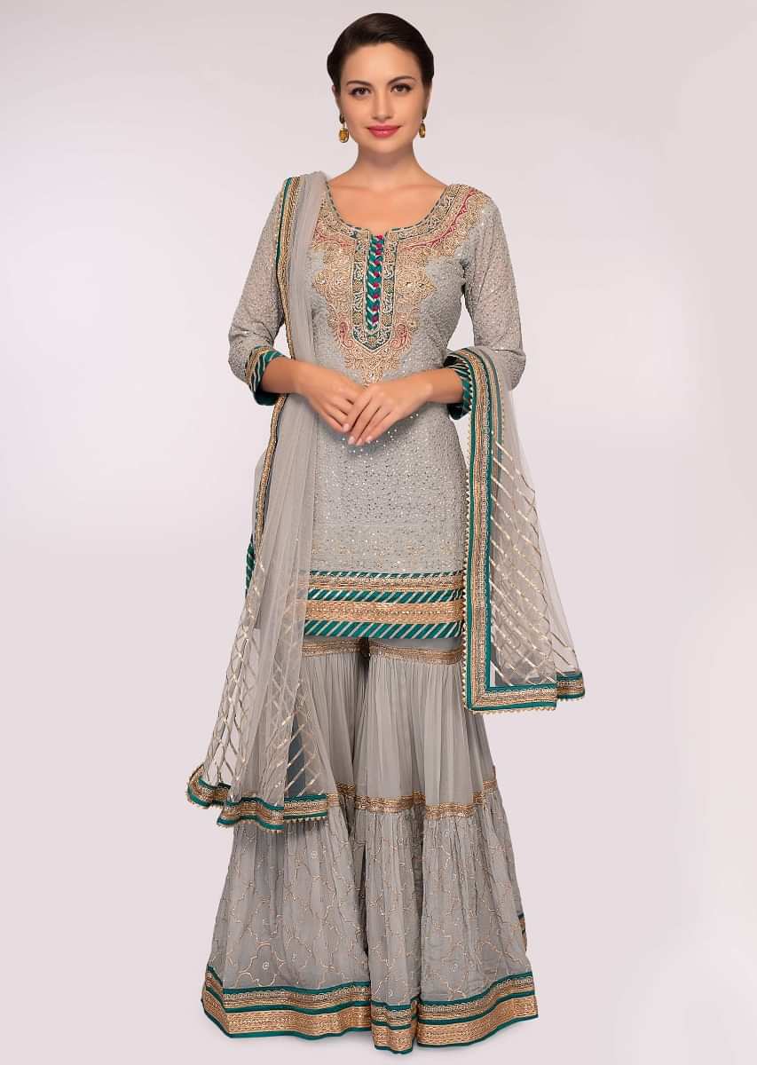 Grey embroidered georgette suit paired with  flared sharara and net dupatta 