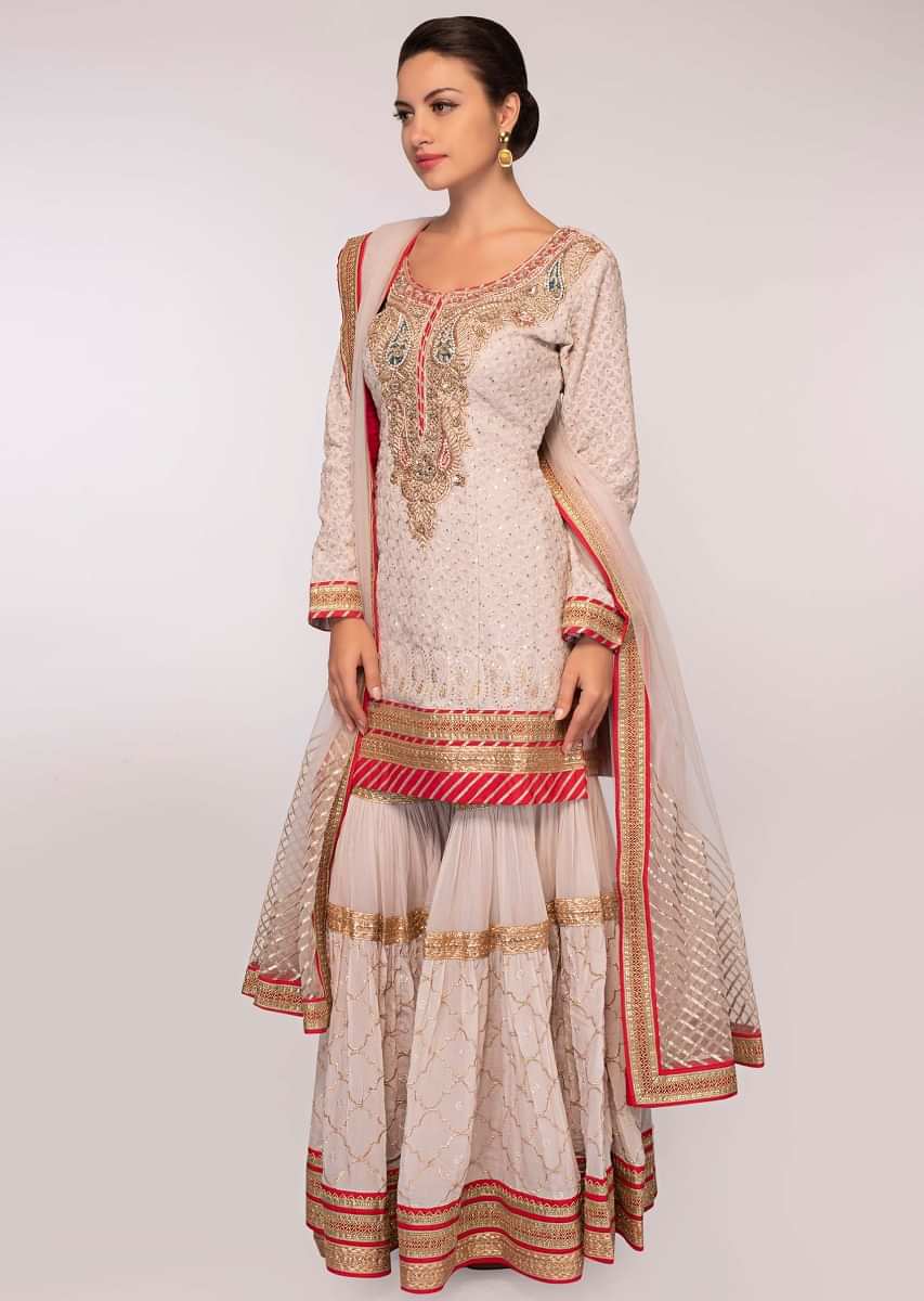Grey embroidered georgette suit paired with  flared sharara and net dupatta