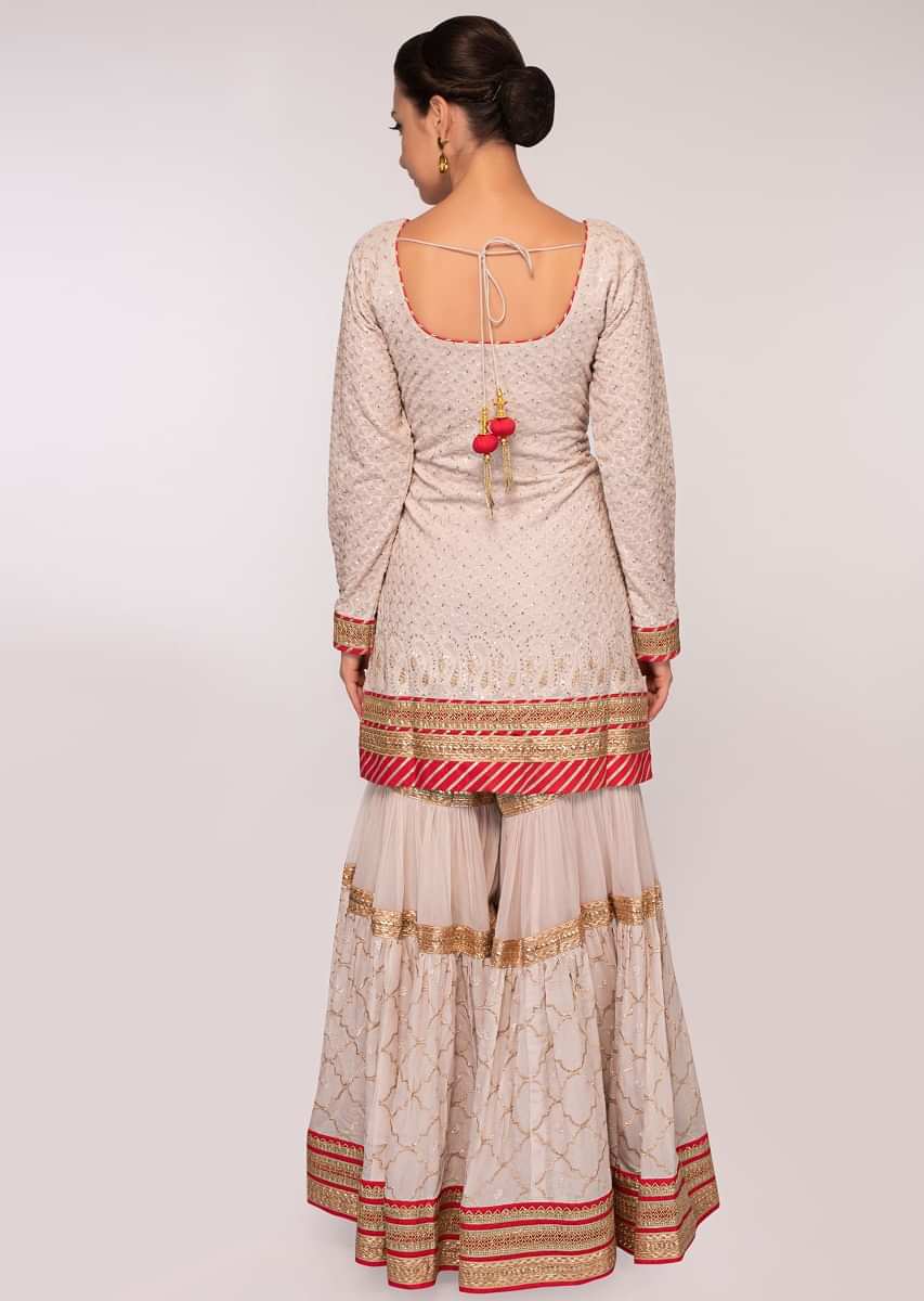 Grey embroidered georgette suit paired with  flared sharara and net dupatta