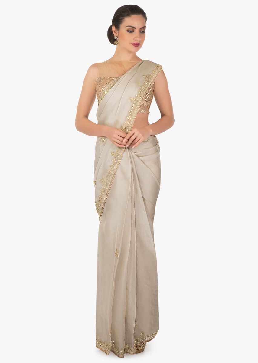 Grey tissue silk saree in gotta patch and motif embroidery only on Kalki
