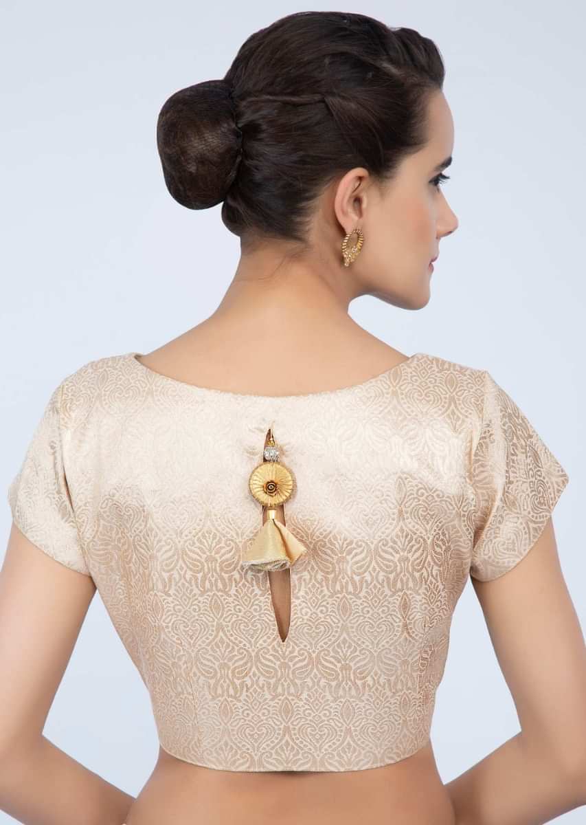 High neck cream brocade blouse with cut out at the back only on Kalki