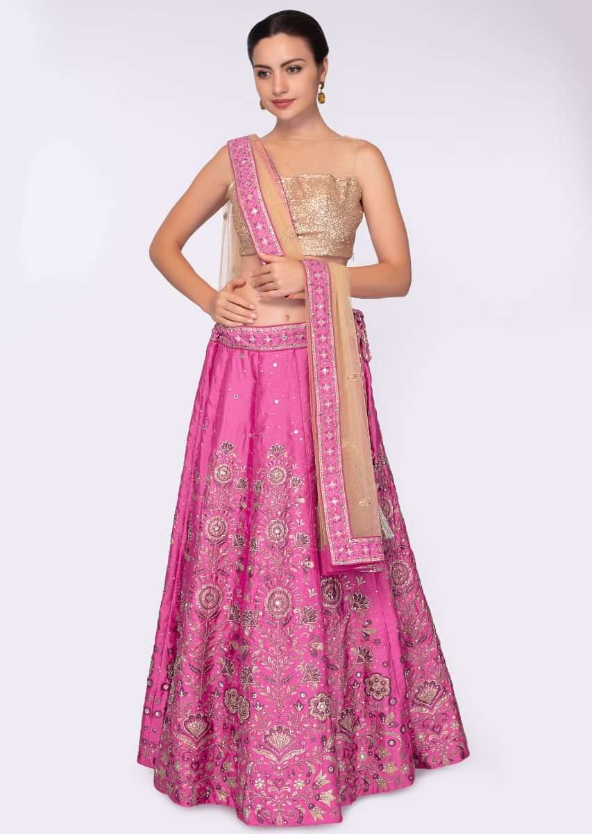 Hot pink banarasi silk lehenga in floral  foil print paired with beige net dupatta 