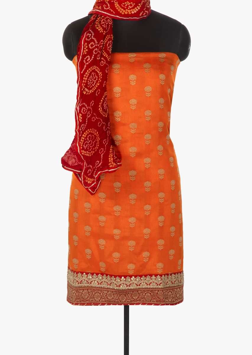 Orange weaved unstitched suit in silk with brocade border only on Kalki