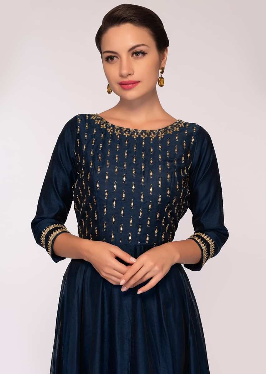 Indigo blue silk anarkali matched with a contrasting yellow cotton dupatta in floral embroidery