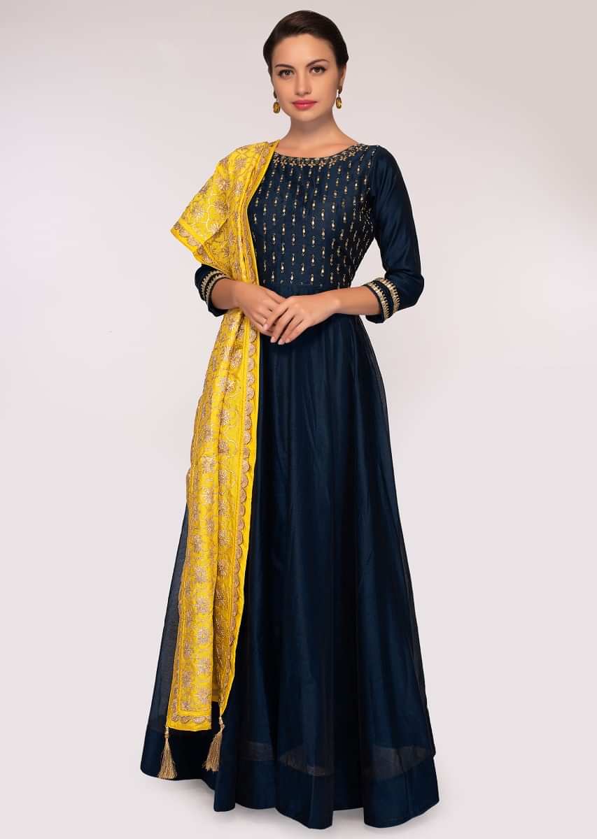 Indigo blue silk anarkali matched with a contrasting yellow cotton dupatta in floral embroidery