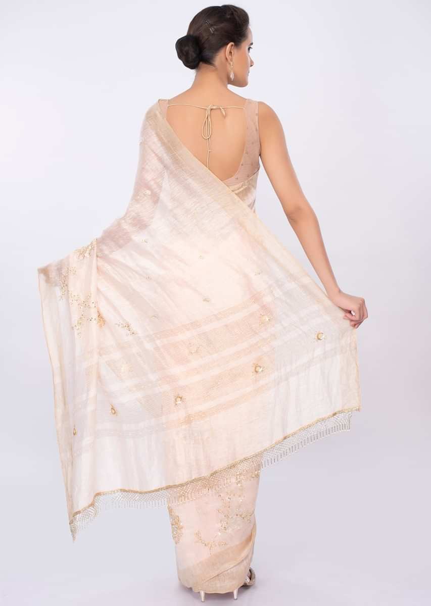 Ivory linen saree in floral jaal embroidery only on kalki
