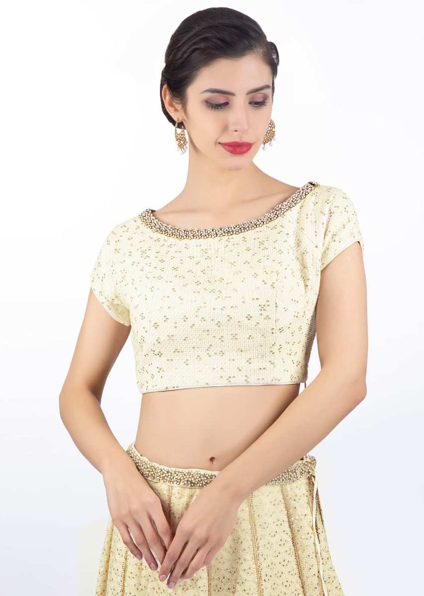 Ivory thread embroidered lehenga paired with a matching round neck blouse and chiffon dupatta