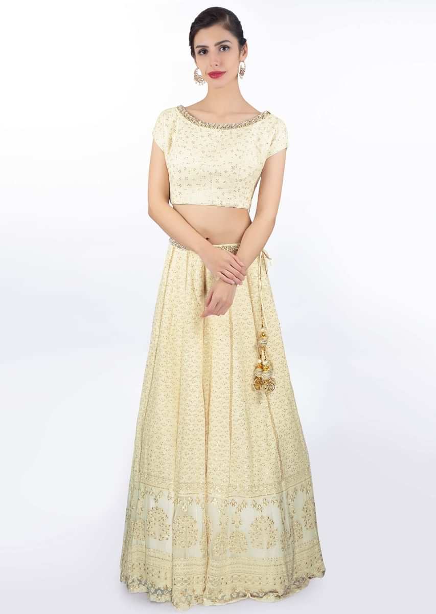 Ivory thread embroidered lehenga paired with a matching round neck blouse and chiffon dupatta