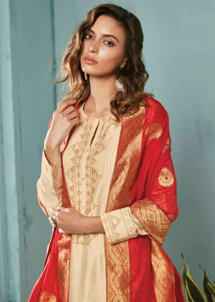 Ivory unstitched suit adorn in geometric motif printed placket matched with red dupatta