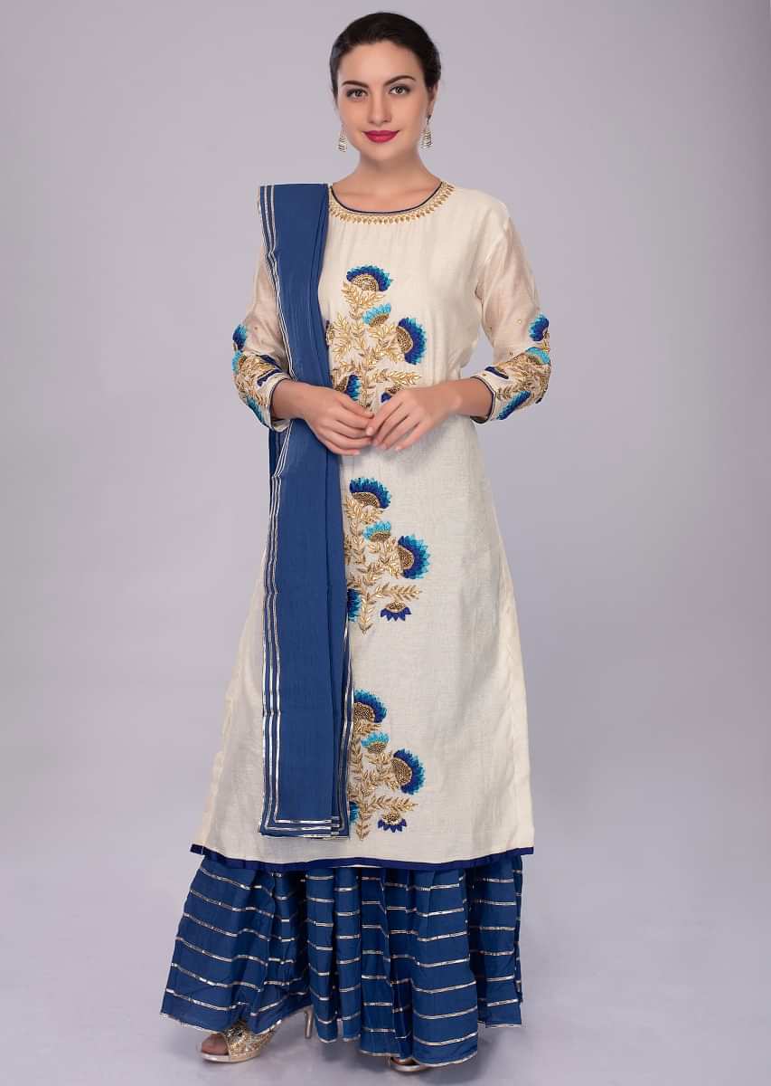 vory white suit with center embroidered butti with cobalt blue sharara and dupatta 