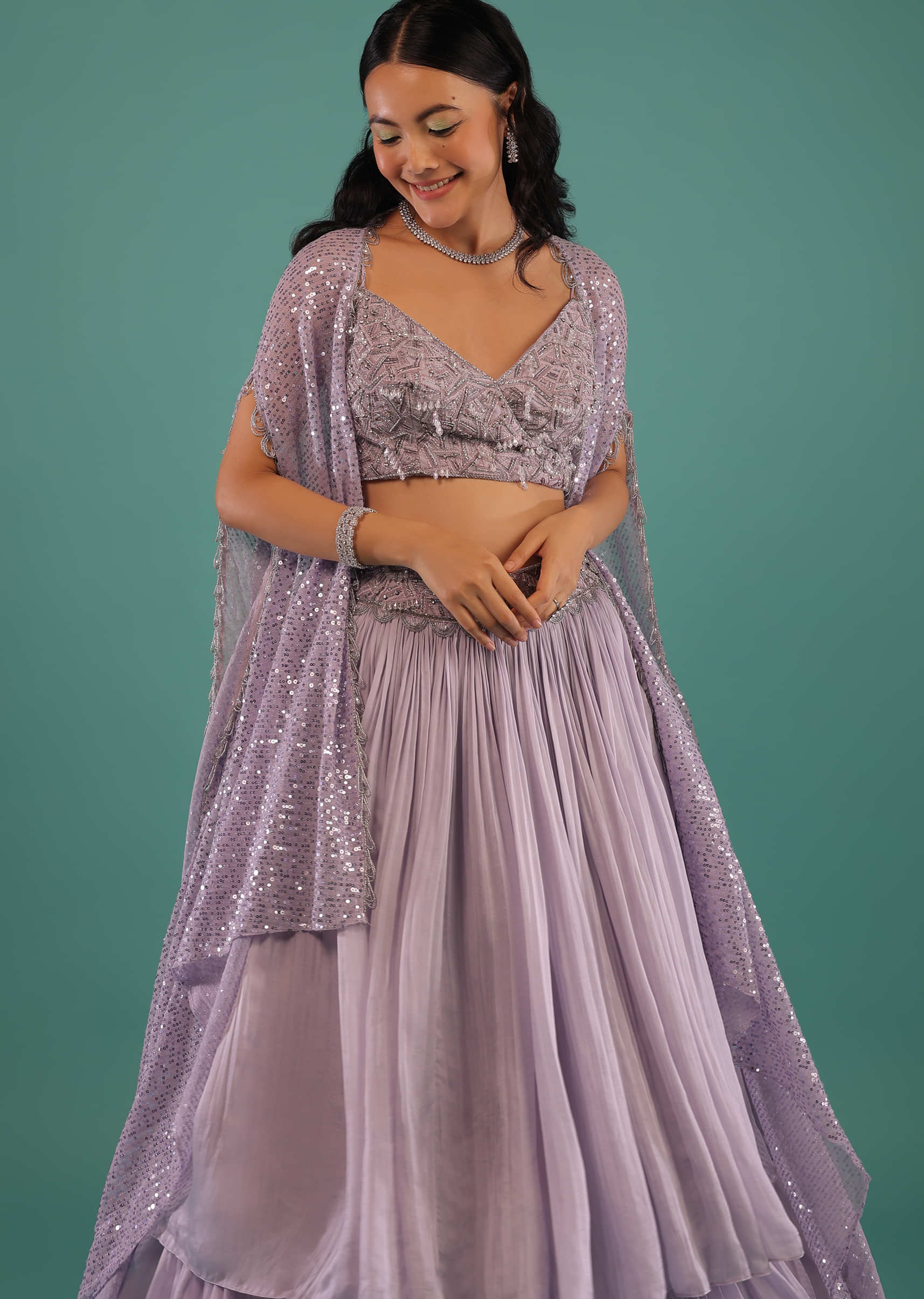 Lavender Layered Skirt With A Resham And 3D Beads Embroidered Crop Top And High Low Sequins Cape
