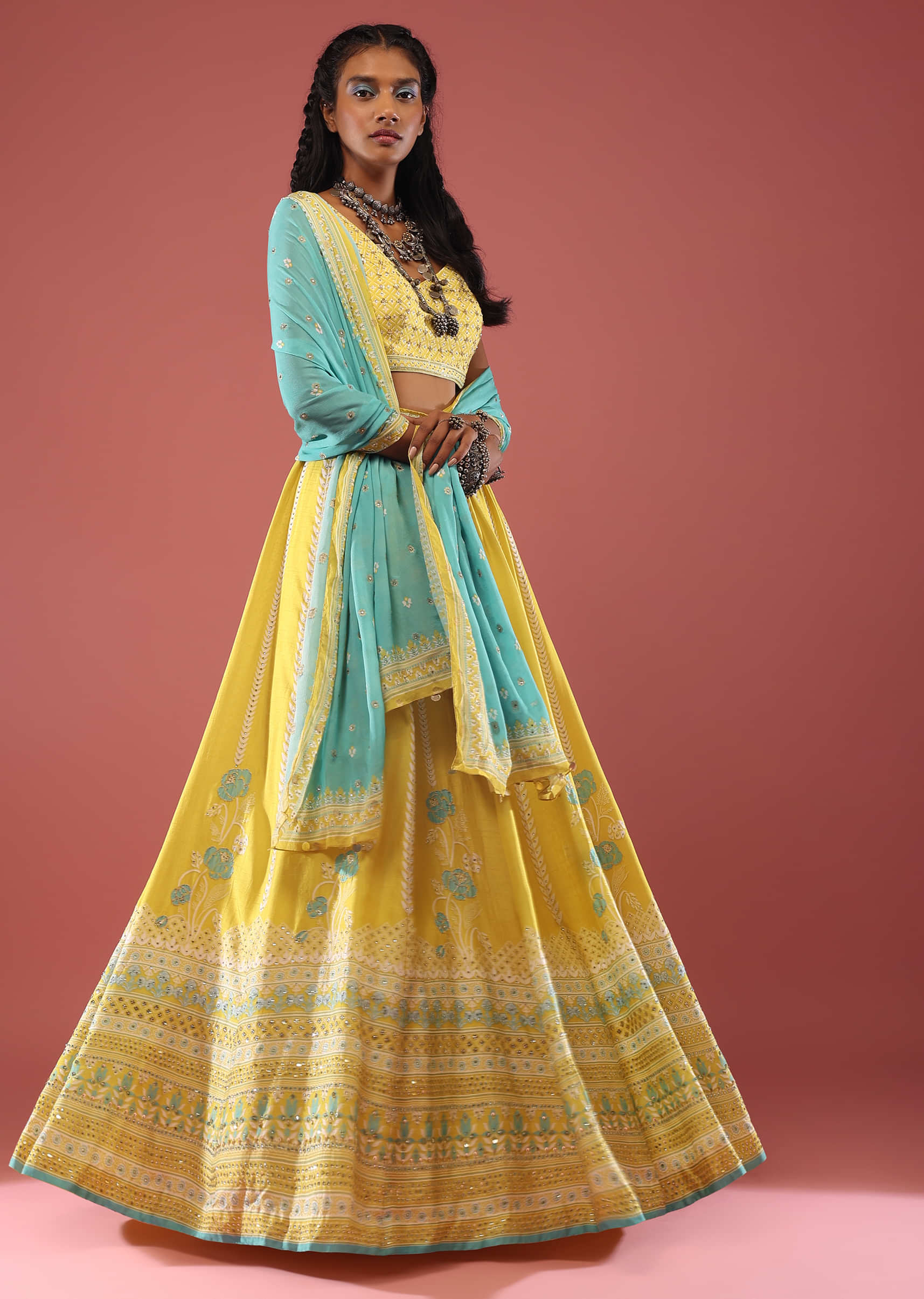 Lemon Yellow Lehenga With Floral Print And A Well-Embroidered Silk Blouse Are Paired With A Blue Chiffon Dupatta
