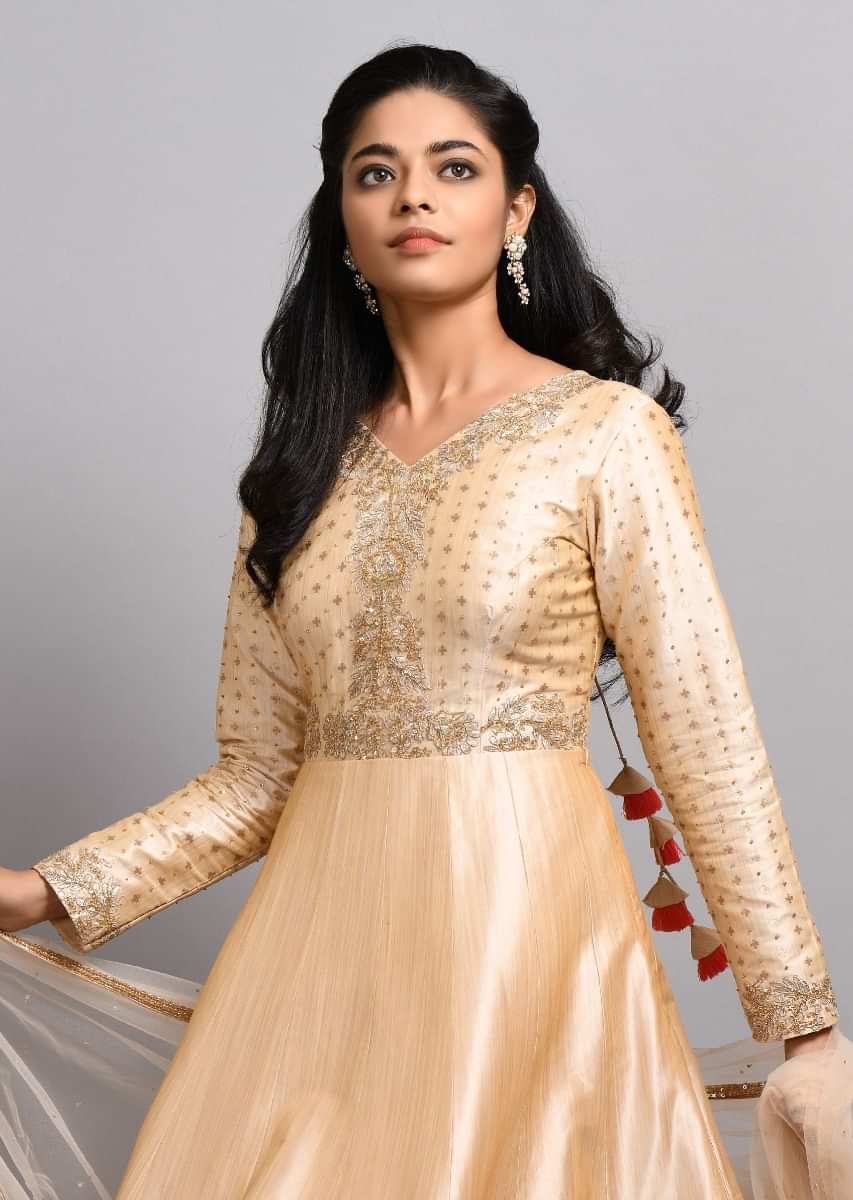 Light beige anarkali suit in silk with brocade butti and gotta patch embroidery
