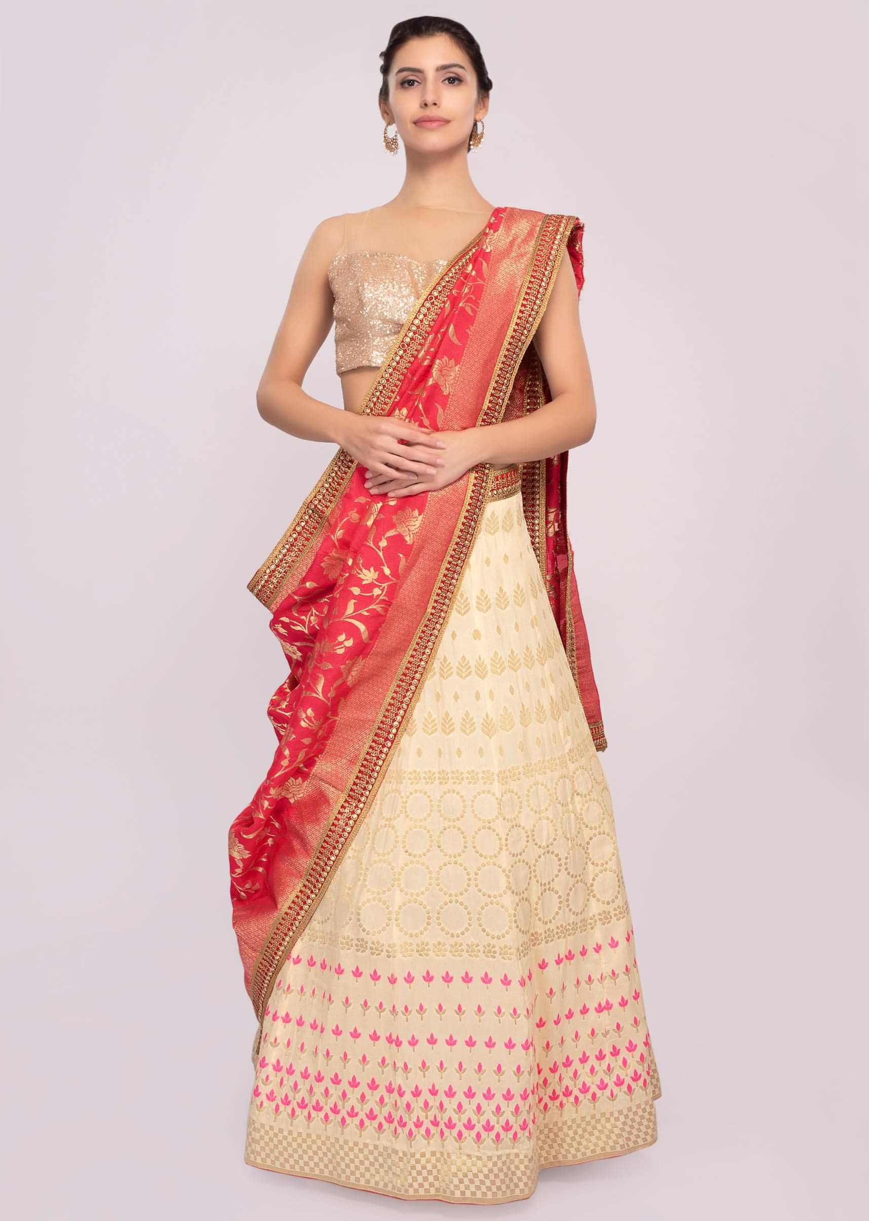 Light cream cotton silk weaved lehenga paired with fushia pink weaved dupatta