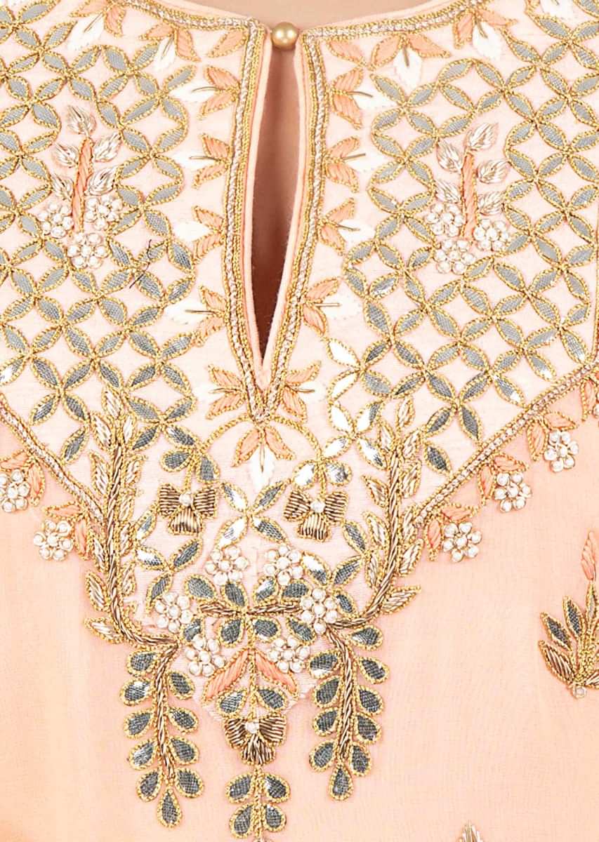 Light peach embroidered georgette suit paired with weaved palazzo and matching chiffon dupatta