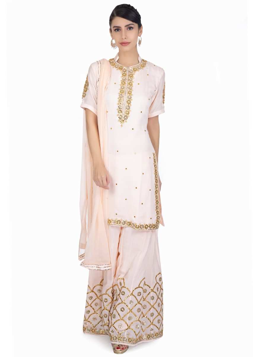 Light peach gotta patch embroidered suit paired with matching palazzo and chiffon dupatta