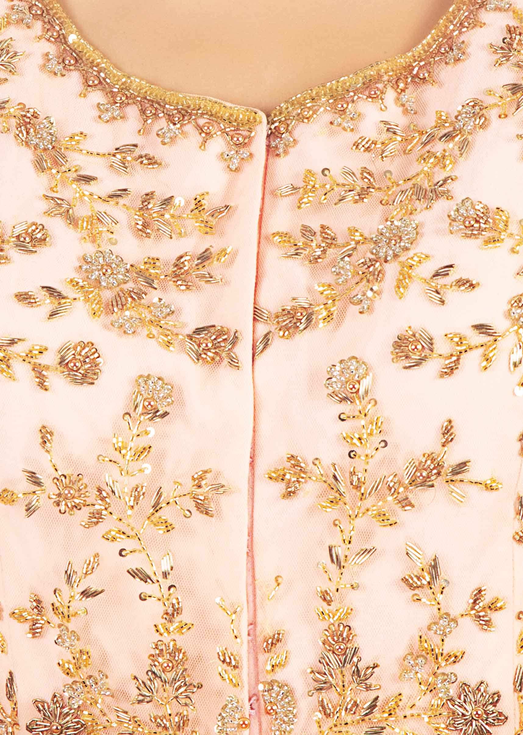 Light peach raw silk lehenga paired with long embroidered net jacket and dupatta
