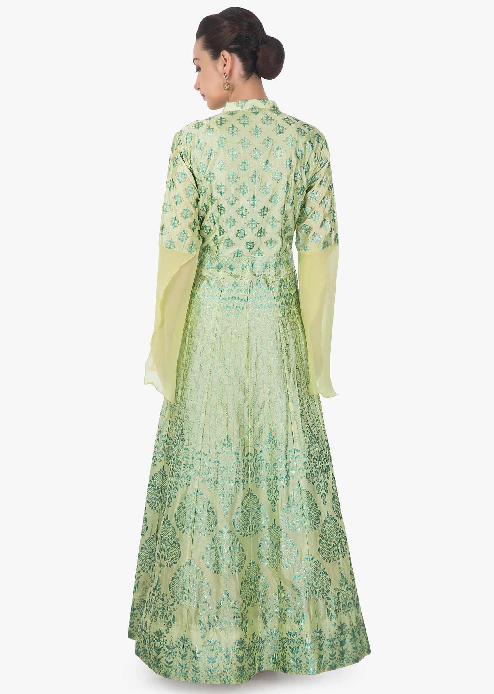 Light pista green suit featuring with foil printed butti and fancy buttons only on Kalki