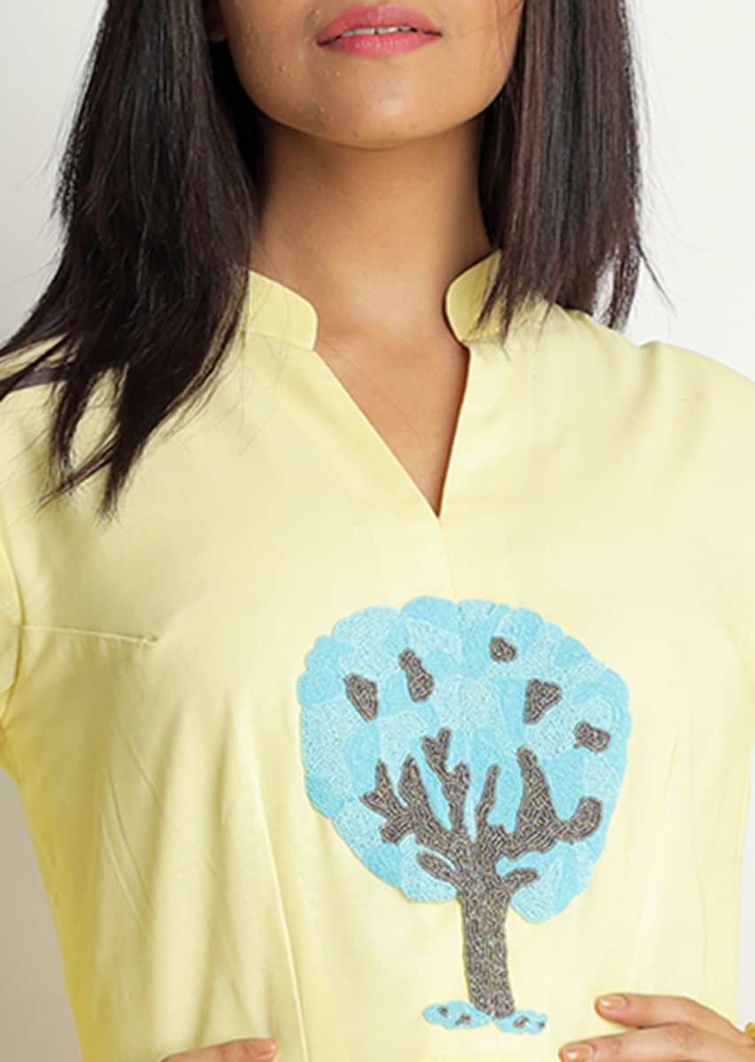 Light yellow tunic dress with blue and grey motif embroidered butti