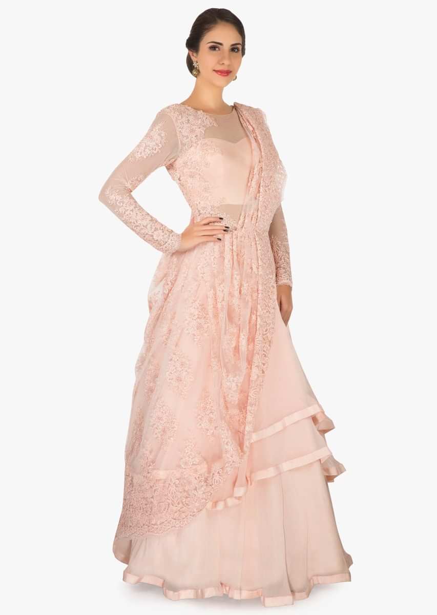 Light Peach gown in georgette with ready pleated pallav embellished with moti work only on Kalki