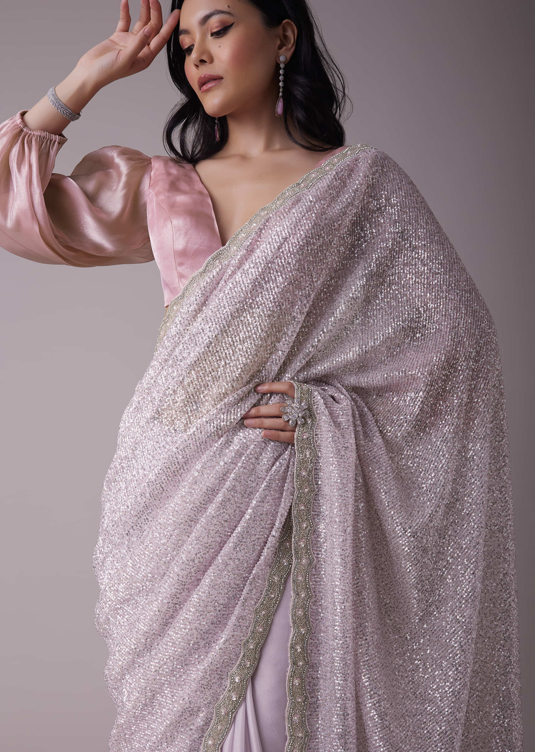 Lavish lavender saree with black sequins border. Fabric: Shimmer Georgette  Saree length:5.5 metres Blouse : full sequins blouse materi