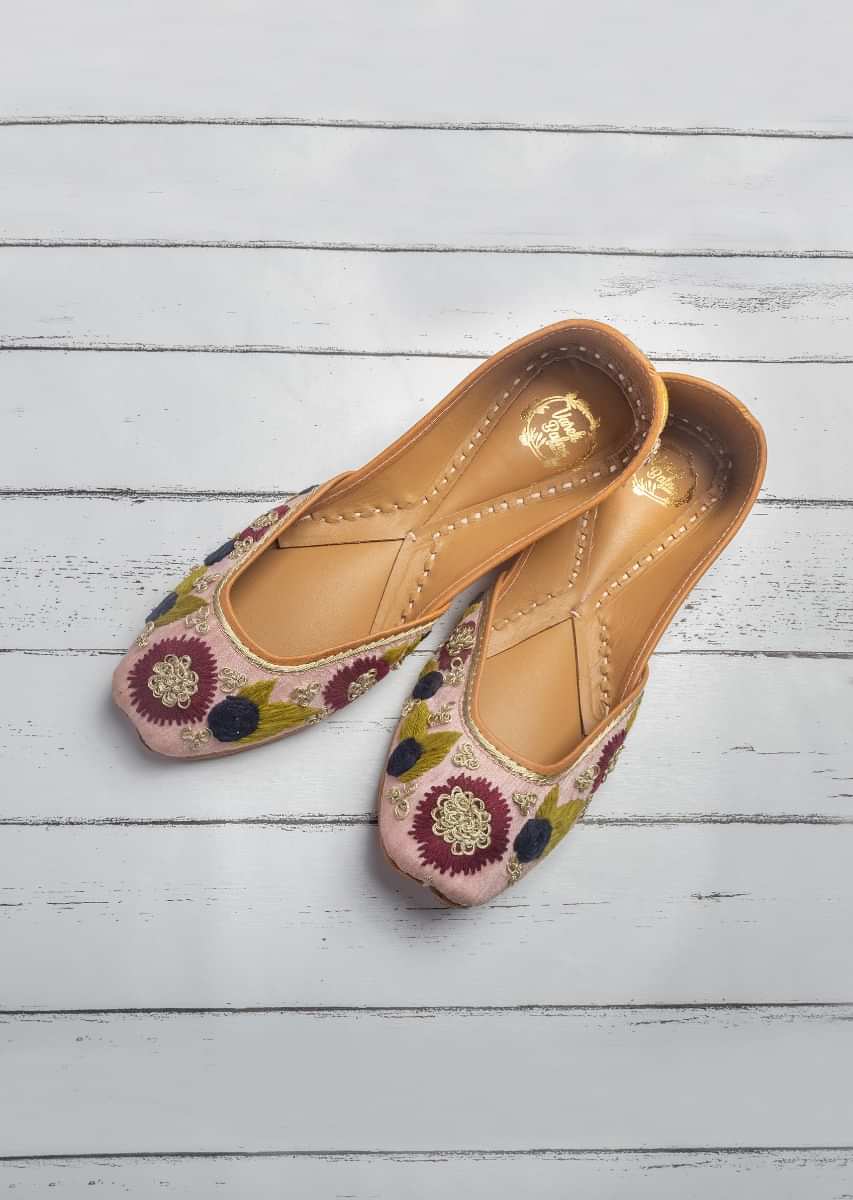Powder Pink Juttis In Raw Silk With Bright Thread And Zari Embroidered Flowers By Vareli Bafna