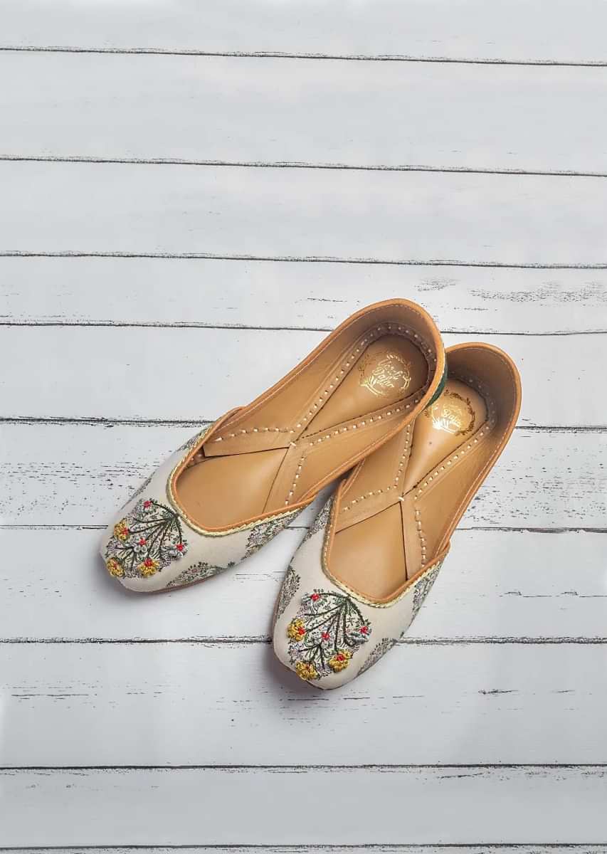Daisy White Juttis In Cotton Satin Highlighted Buta With French Knot And Bead Work By Vareli Bafna