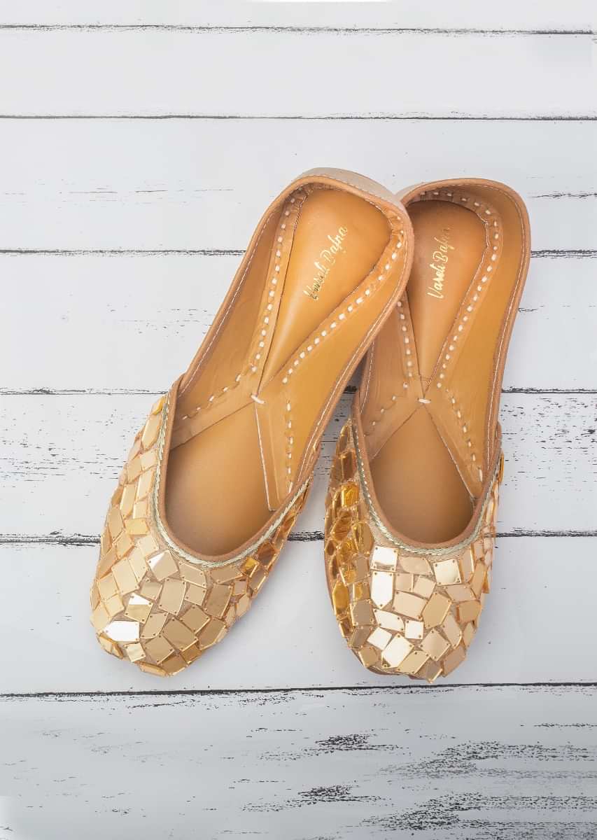 Gold Juttis In Raw Silk With Gold Acrylic Mirror Work In Mosaic Pattern By Vareli Bafna