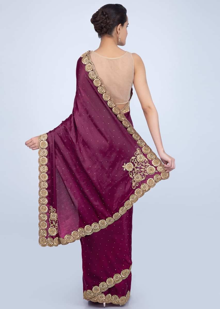 Magenta satin saree with golden scallop embroidered pallo only on Kalki