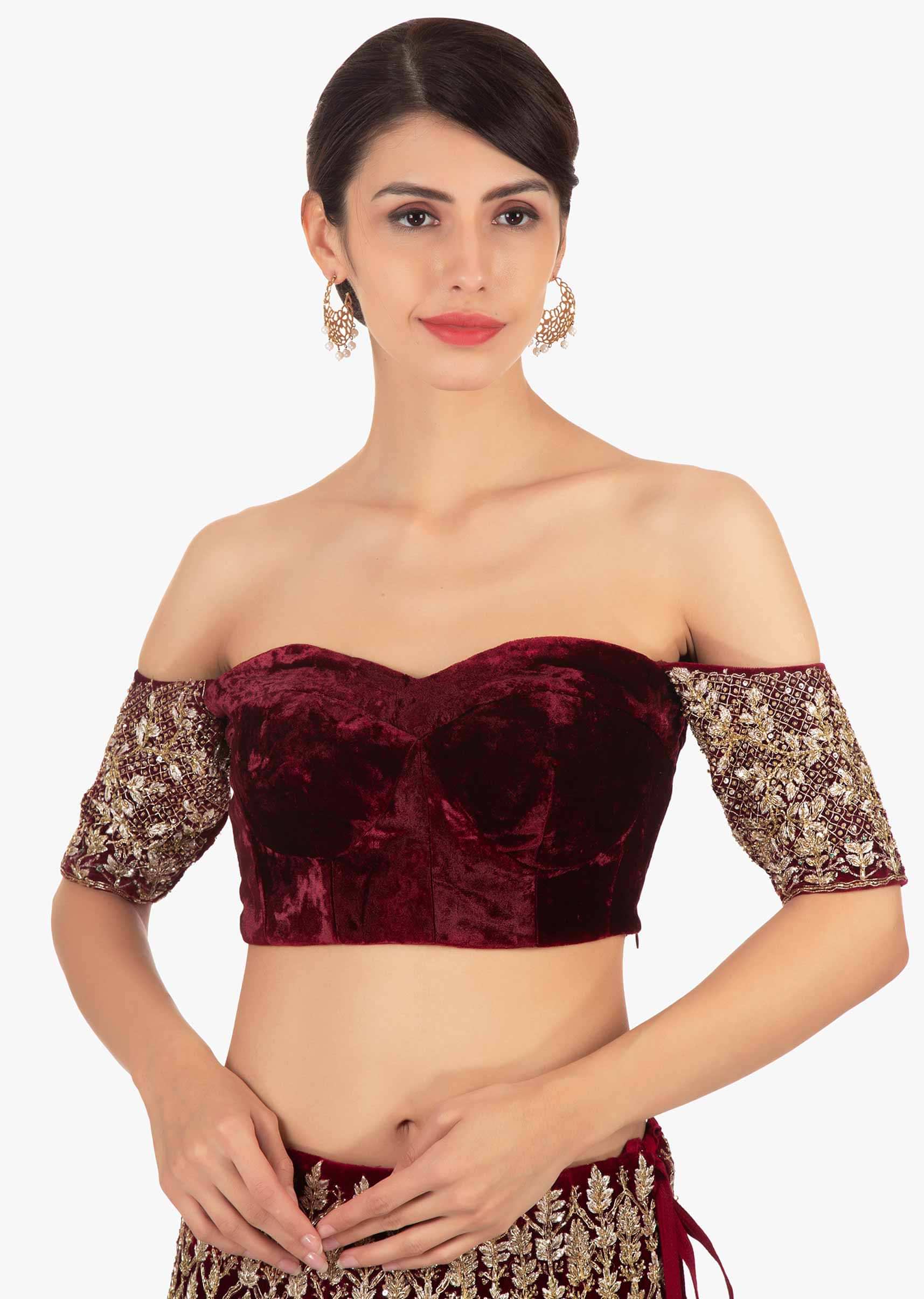 Maroon off shoulder blouse paired with embellished lehenga and pink net dupatta