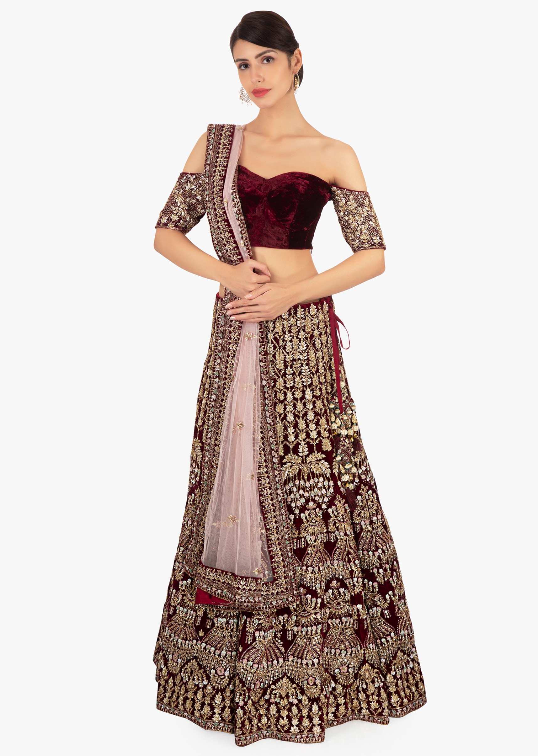 Maroon off shoulder blouse paired with embellished lehenga and pink net dupatta