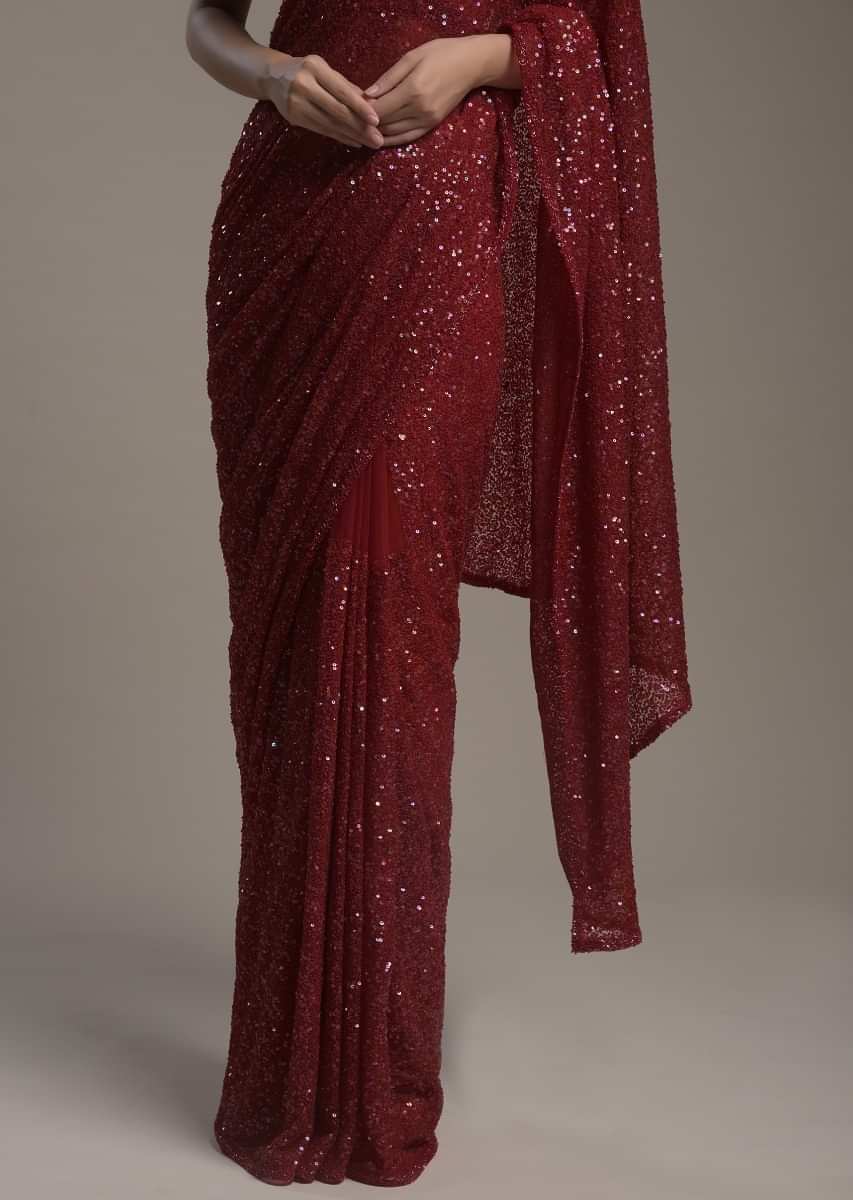 Maroon Saree In Net Heavily Embellished With Sequins And Paired With A Matching Unstitched Blouse