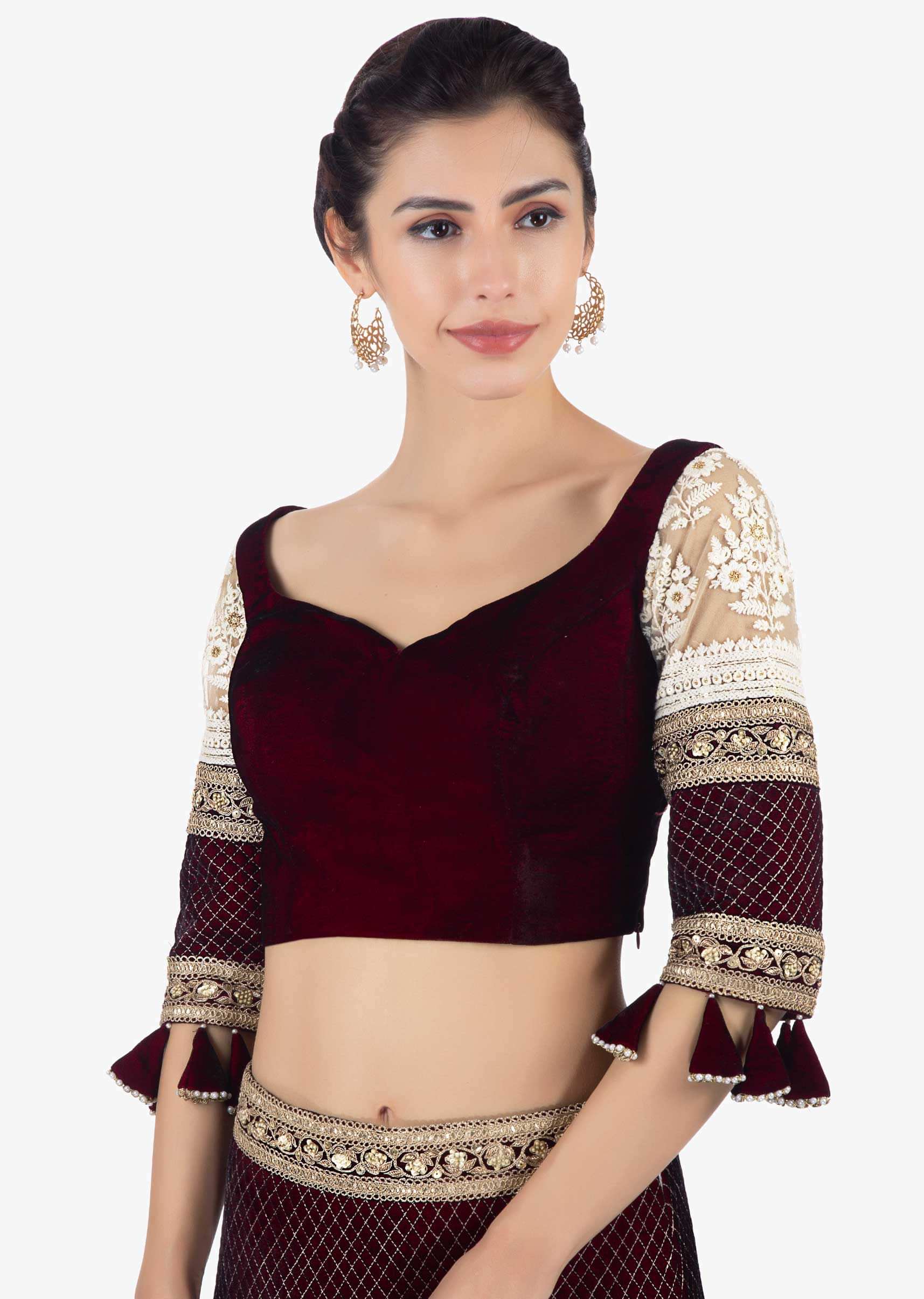 Maroon velvet blouse paired with lehenga in sequins and jaal work and a matching net dupatta 