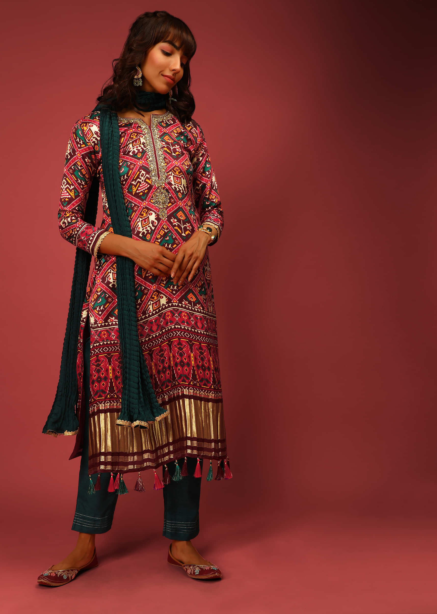 Maroon Straight Cut Suit In Satin Blend With Patola Print And Brocade Border Edged In Tassels  