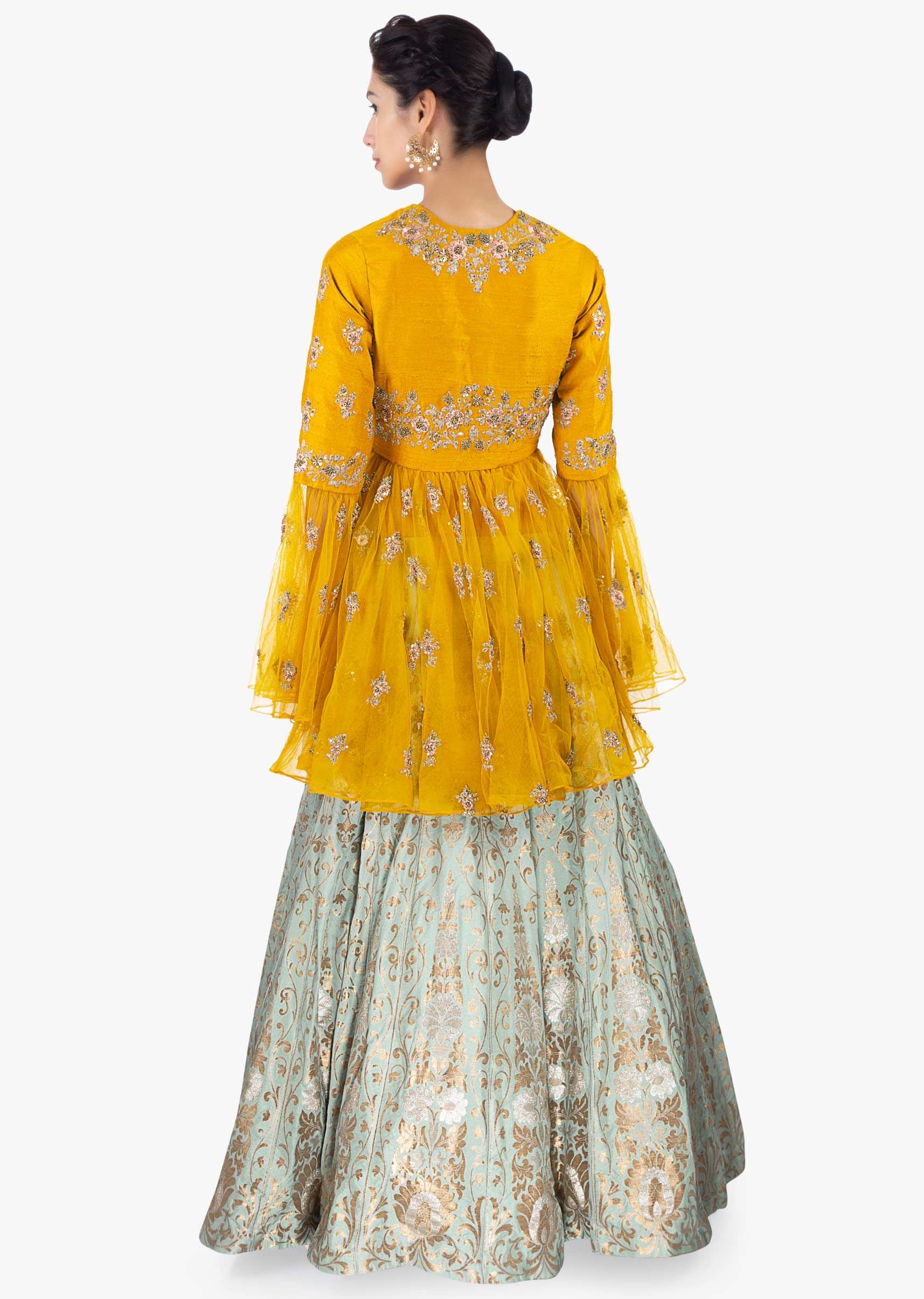 Mint green brocade  lehenga paired with  mustard thigh length long top 