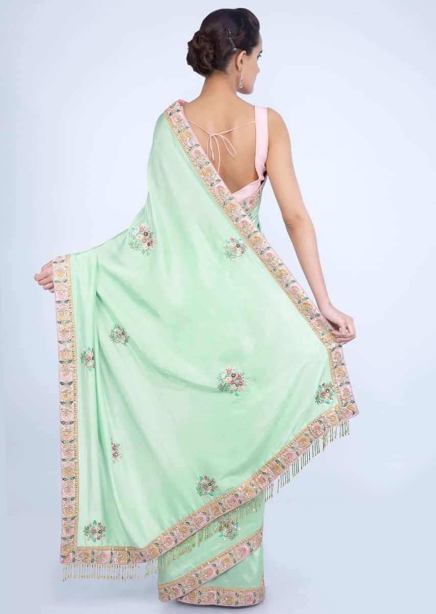 Mint green dupion silk blouse with multi color embroidery and butti only on Kalki