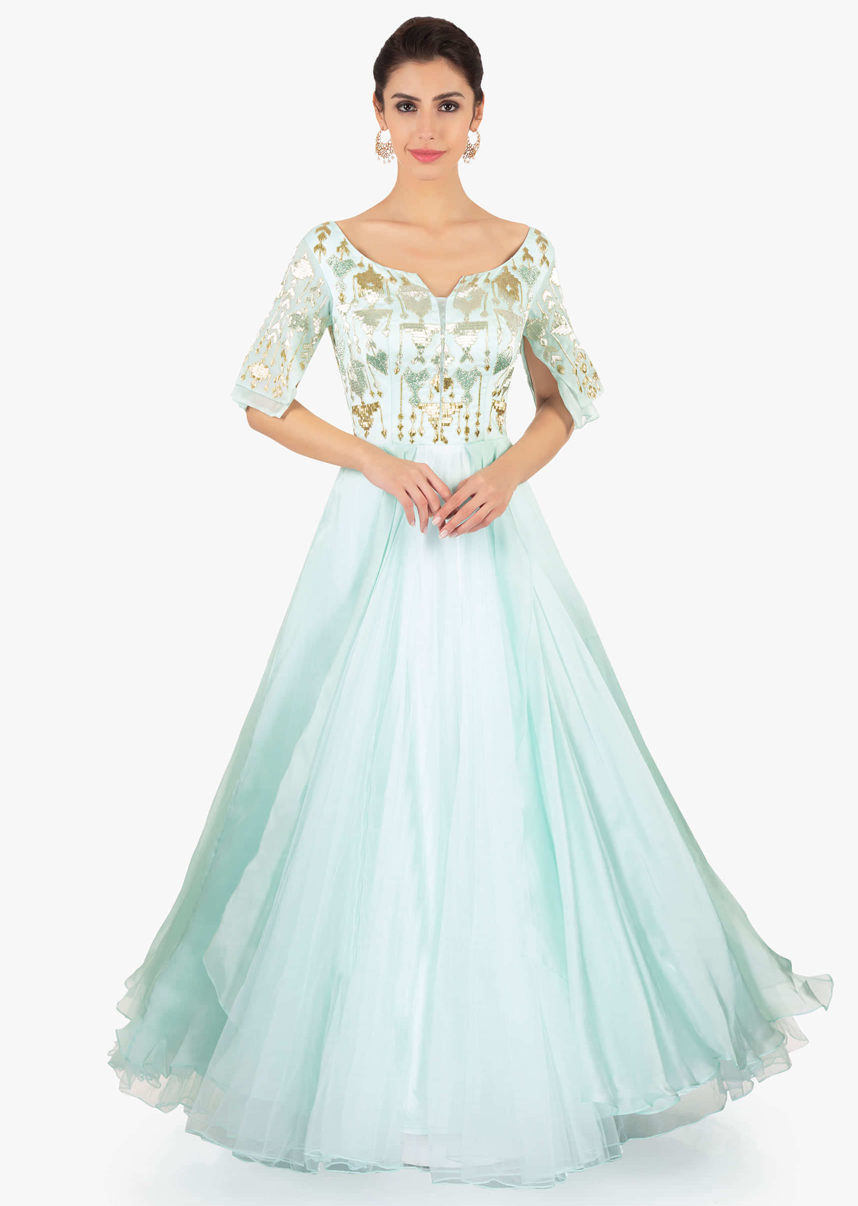 Mint green gown designed with over lapping sleeves and layers 