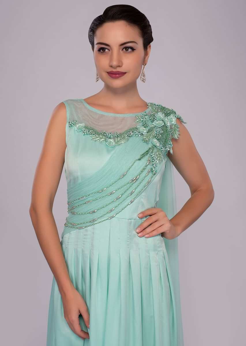 Mint green gown with floral embroidery and pleated bodice