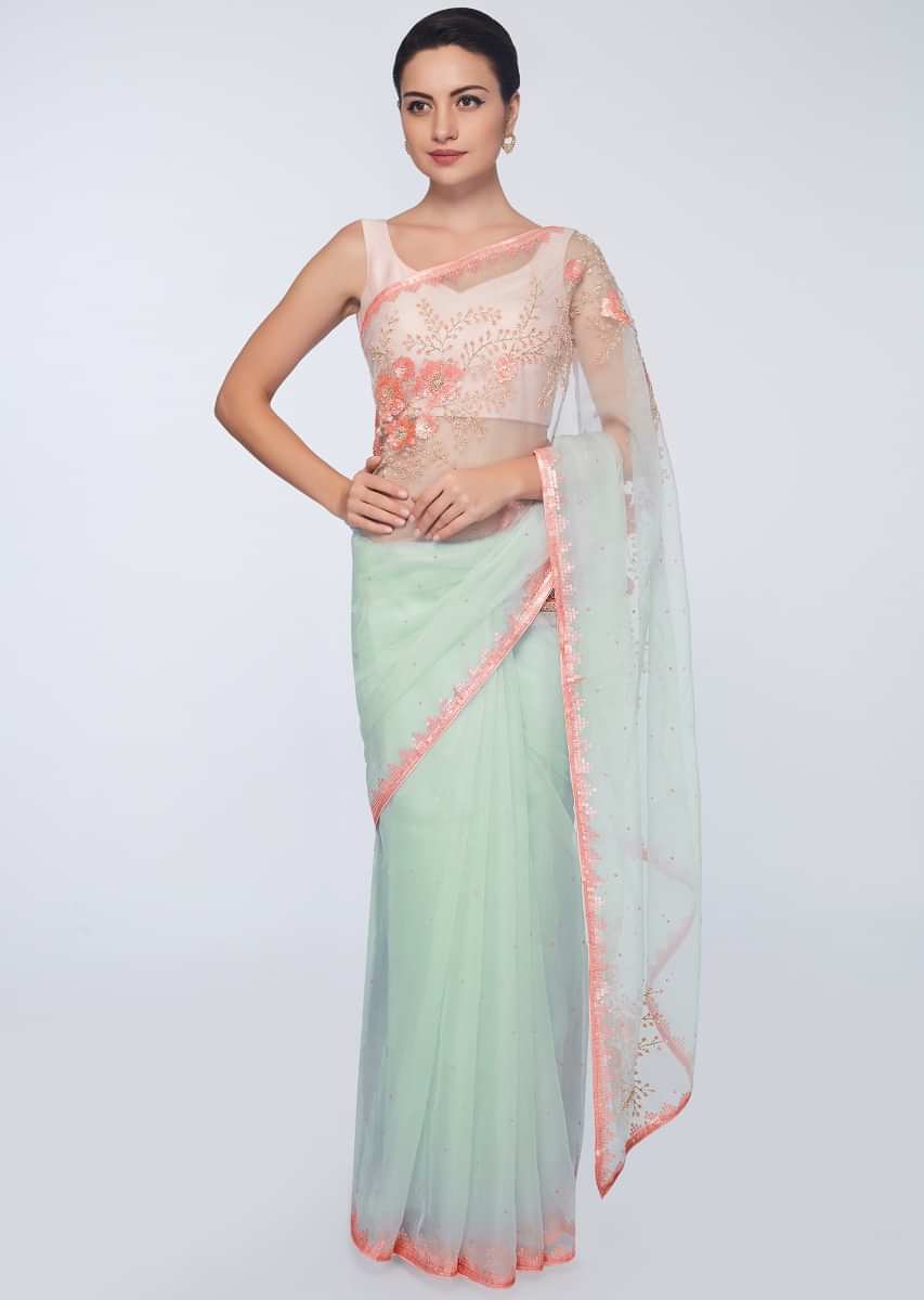 Mint green organza saree featuring in  sequins  and moti embroidery 