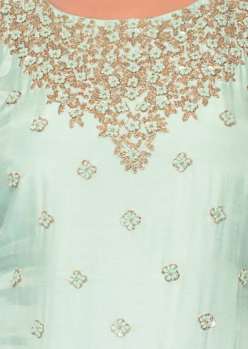 Mint green suit in embroidery and butti paired with net sharara