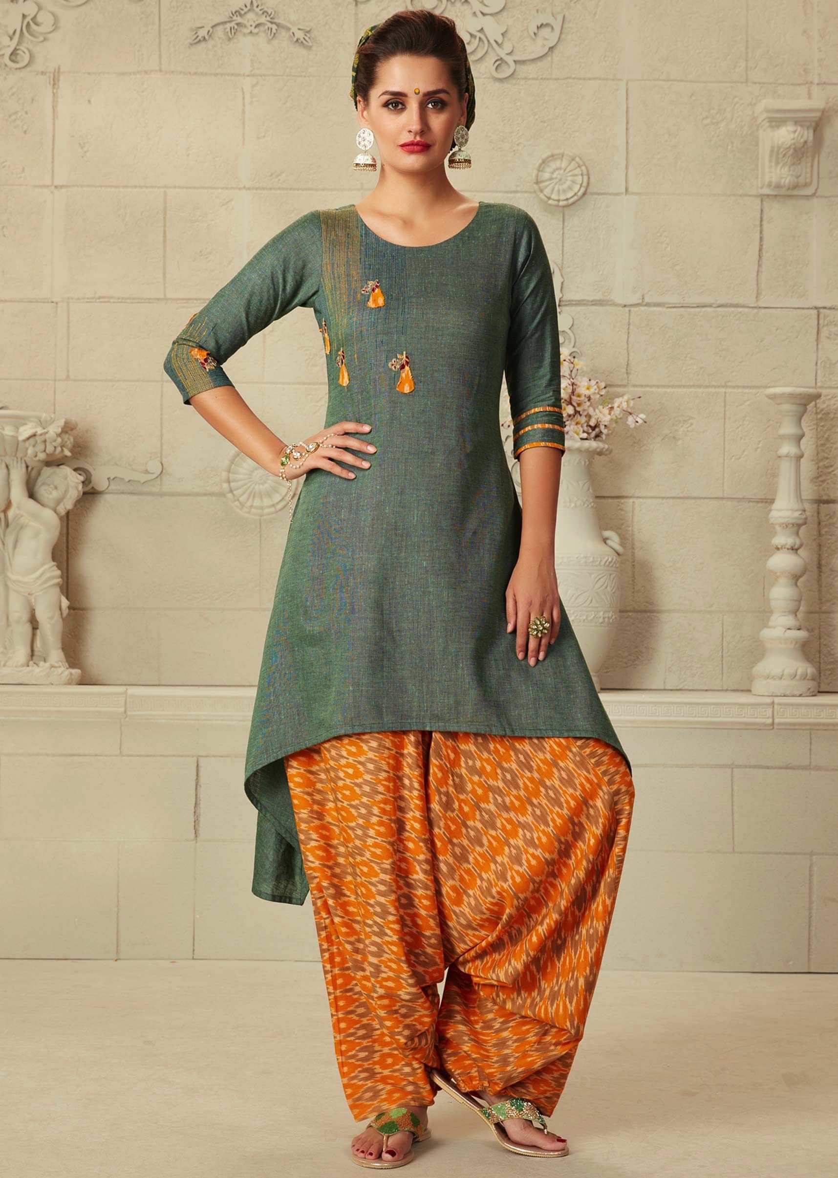 Mud green A line suit with front short and back long matched with ikkat printed salwar only on Kalki