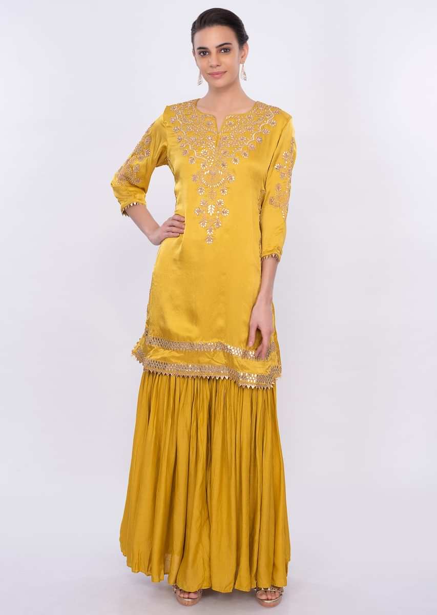 Mustard embroidered sharara suit set with contrasting navy blue dupatta only on Kalki